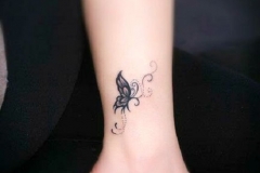 small-butterfly-on-lower-leg-tattoo
