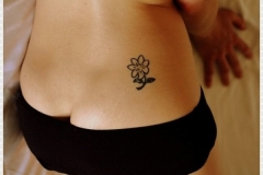 small-flower-tattoo-on-girl-lowerback
